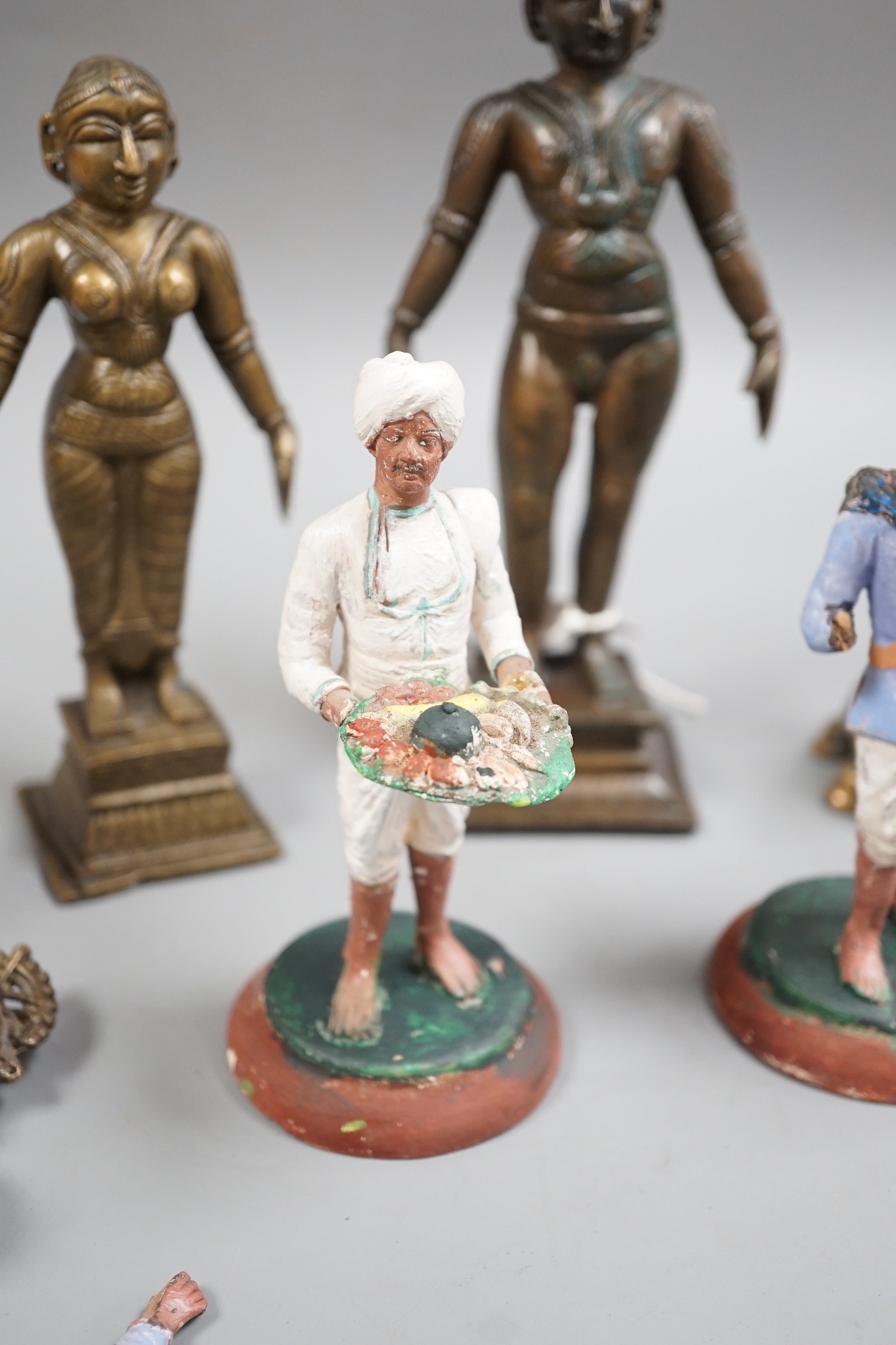 A group of Indian bronze figures of deities, tallest 20 cm and three Indian painted clay figures